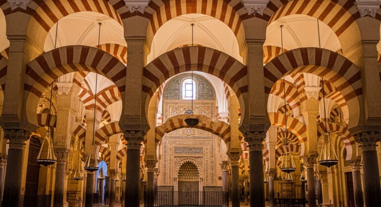 Interior of the Mezquita-Catedral in Córdoba Spain showing red and white horseshoe arches